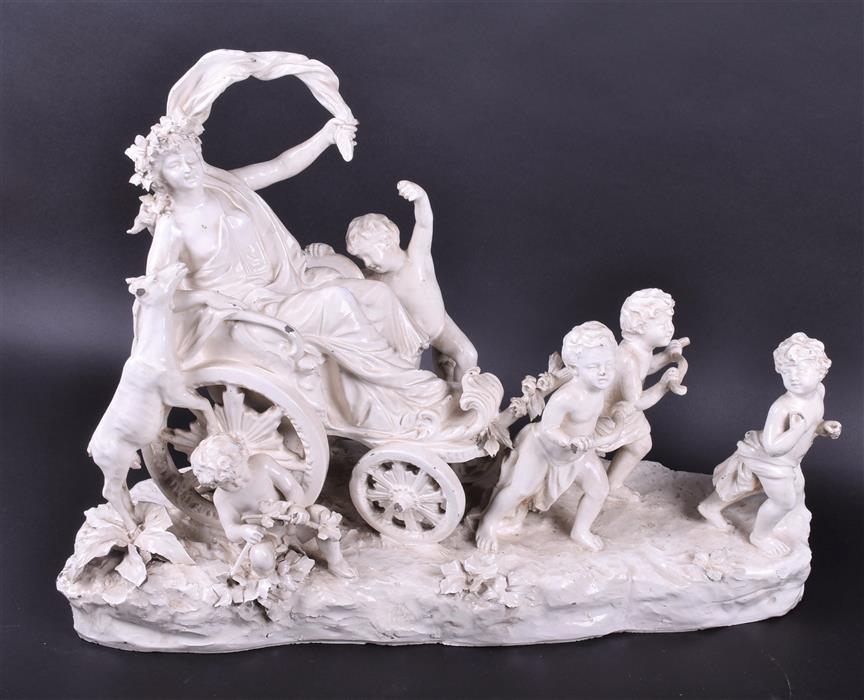 A large 19th century white glazed continental ceramic group Bacchus seated in a cart which is