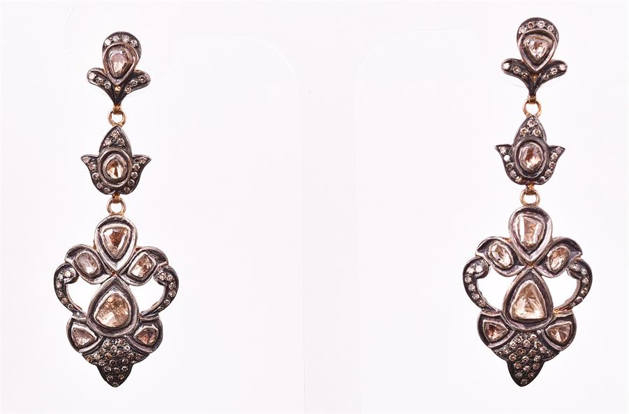 A pair of gilt white metal and diamond triple segment drop earrings set with larger naturalistic - Image 2 of 2