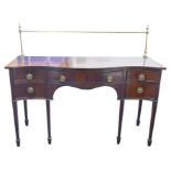 A Georgian style mahogany serpentine fronted sideboard with brass rail back, the plain top over a