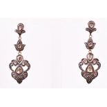 A pair of gilt white metal and diamond triple segment drop earrings set with larger naturalistic