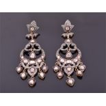 A pair of white and gilt metal diamond chandelier drop earrings each with an open-work mount set