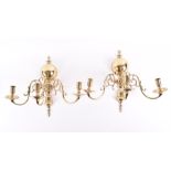 A pair of early 20th century brass three branch wall sconces with scrolling arms and central bulbous