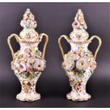 A pair of 19th century Colebrookdale vases and covers heavily decorated with applied flowers and
