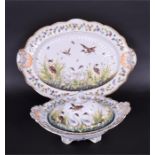 A hand painted Naples ceramic meat plate the plate of oval form, the wrythen ground decorated with
