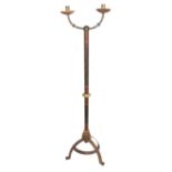 An antique wrought iron and painted floor candlestick in the manner of William Burgess, with twin