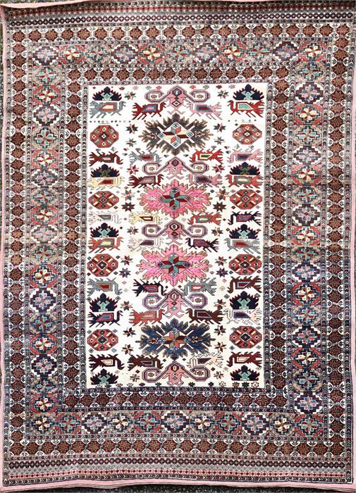 A Persian cream and iron red ground rug polychrome decorated with central rectangular frame