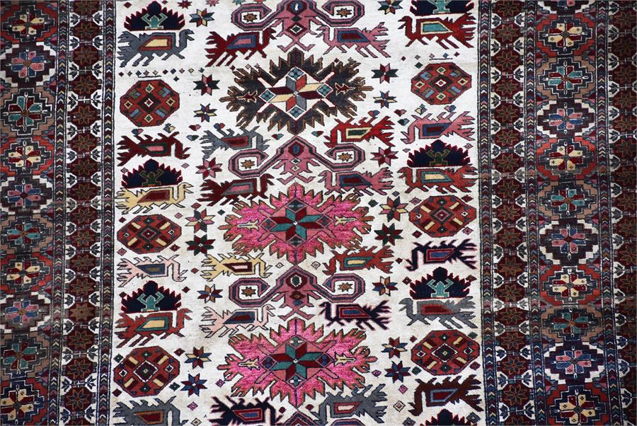 A Persian cream and iron red ground rug polychrome decorated with central rectangular frame - Image 4 of 4