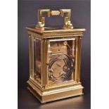 A brass cased carriage clock by Matthew Norman of London the white enamelled dial with black Roman