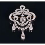 A late 19th century diamond brooch the bow-shaped ribbon mount pavé-set with diamonds, surmounted