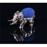 A novelty silver pin cushion in the form of an elephant with a blue cushioned back, approximately