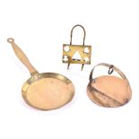 Three pieces of miniature nineteenth century brass domestic wares including a skillet and stand.