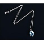 A 9ct white gold and blue topaz pendant the oval cut topaz of approximately 4.0 carats, suspended on