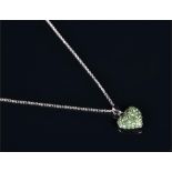 An 18ct white gold and demantoid garnet heart-shaped pendant claw set with round brilliant cut green