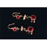 A pair of yellow metal and synthetic red gemstone drop earrings each set with two round red