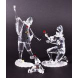 Three Swarovski figurines of clowns to include a Pierrot proffering a rose, 20cm high, a clown