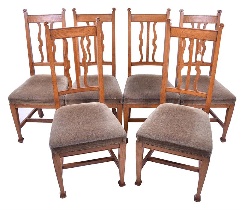 A set of six Robson & Co. oak framed Arts and Crafts chairs  with green fabric seats, with carved