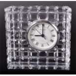 A Waterford cut crystal mantel clock inset with a white dial with black Roman numerals. Signed to