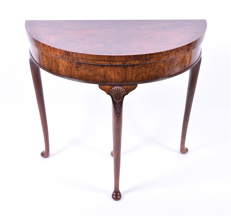 A Queen Anne style demi-lune walnut card table with cabriole legs, 81.5 cm diameter, 73.5 cm high.