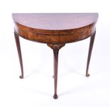 A Queen Anne style demi-lune walnut card table with cabriole legs, 81.5 cm diameter, 73.5 cm high.