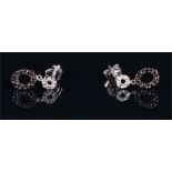 A pair of 18ct white gold and black and white diamond drop earrings suspended with delicate openwork