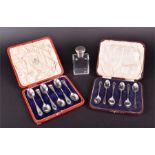 Two cased sets of six silver spoons together with a small silver topped glass bottle spoons with