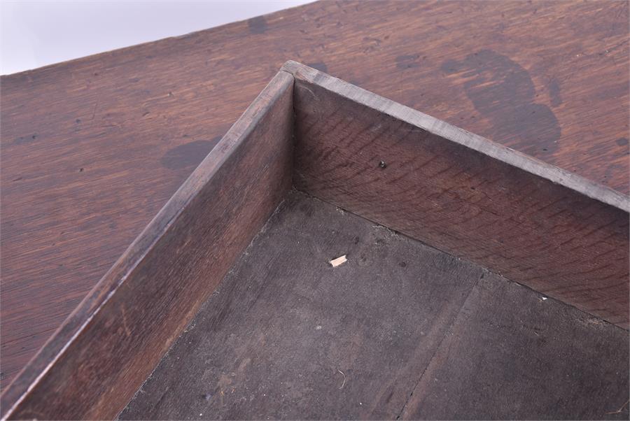 An 18th century oak lowboy the rectangular top with moulded rim, over three small drawers with brass - Image 2 of 3