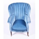 A Georgian style wing armchair the fluted back with scrolled arms, blue upholstery and a loose