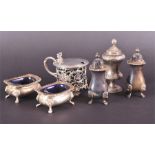 An assortment of silver items to include a mustard with reticulated scrolling body five salts of