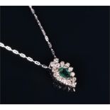 A white metal, diamond, and green tourmaline pendant set with a pear cut tourmaline surrounded by