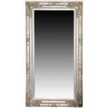A large and impressive contemporary wall mirror the moulded silvered frame with scrolling foliate