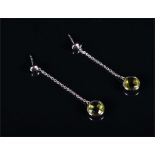 A pair of 18ct white gold and peridot earrings each suspended with a round faceted cut peridot, 4.