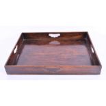A 19th century mahogany butler's tray with pierced grip handles and brass-banded sides, 70 cm long,