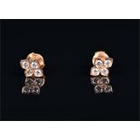 Cartier. A pair of 18ct yellow gold and diamond earrings of quatrefoil form, each set with four