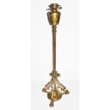 A Victorian brass standard lamp the tripod base with pierced scrolling framework terminating in