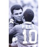 A signed black and white photograph of Pele and Muhammed Ali signed by Pele, framed and glazed, with