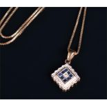 A 9ct yellow gold, diamond, and sapphire pendant the diamond-shaped mount calibre set with square