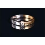 An 18ct white and yellow gold diamond ring suspension set with a round brilliant cut diamond of