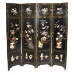 A 20th century Japanese lacquered four-sectional screen or room divider the black ground decorated