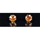 A pair of 9ct yellow gold and citrine ear studs each set with a faceted round cut orange citrine,