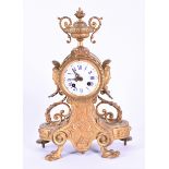 A Victorian gilt metal mantel clock signed Pre Le Masson to movement and numbered 3918, a Greek