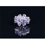 A 9ct white gold and tanzanite cluster ring set with ten pear-cut tanzanites, size N, 3 grams.
