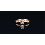 An 18ct yellow gold and diamond ring set with a baguette cut diamond of approximately 0.30 carats,