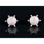 An unusual pair of 14ct white gold and diamond cluster earrings each pavé-set to centre with round