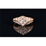 An 18ct yellow gold and diamond ring calibre set with four princess cut diamonds within a diamond-