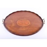 An Edwardian mahogany butler's tray of oval form, with raised gallery, central satinwood shell inlay