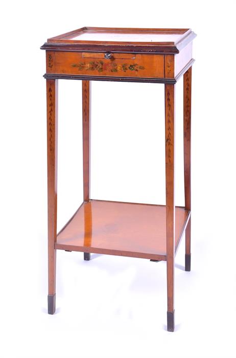 An Edwardian Sheraton Revival painted satinwood stand painted all over with flowers, the top with