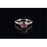 An 18ct white gold, diamond, and tourmaline ring set with a round brilliant cut pale pink tourmaline