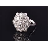 An impressive white gold and diamond cluster ring set with 19 round brilliant cut diamonds of