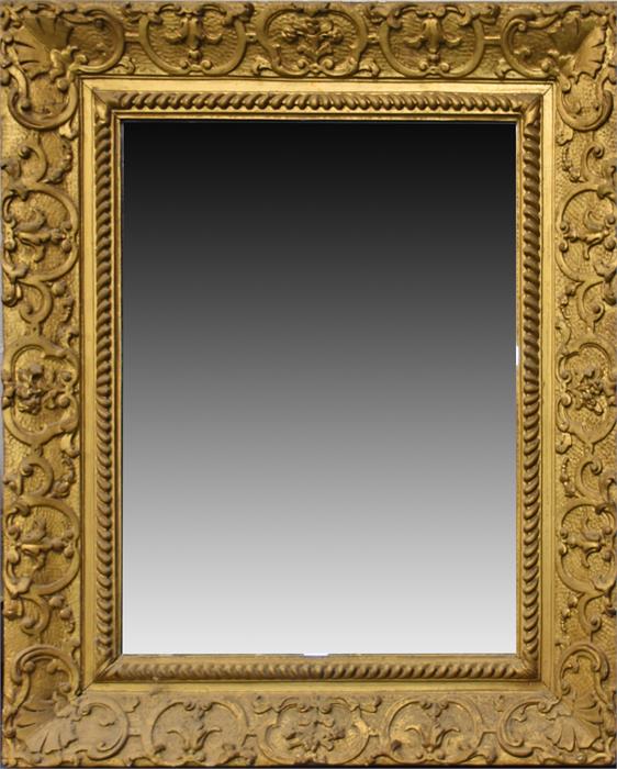A large late 19th / early 20th century gilded wall mirror  the moulded plaster frame with