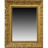 A large late 19th / early 20th century gilded wall mirror  the moulded plaster frame with